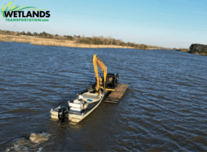 CAT Excavator on Barge Traveling Through River for Remote Site Access